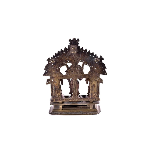 217 - An Indian brass shrine with Vishnu flanked by consorts Sridevi & Bhudevi, beneath a Shesha canopy, t... 