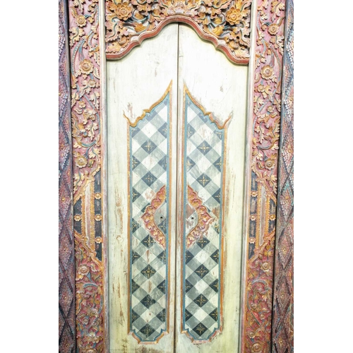 230 - A pair of Islamic style doors, 20th century, carved and painted with flowers and criss cross lines, ... 