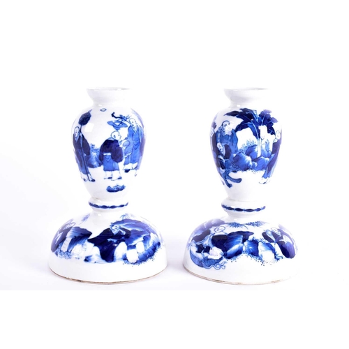 241 - A pair of Chinese blue & white baluster form candlesticks, ing, 20th century, painted with Buddhist ... 