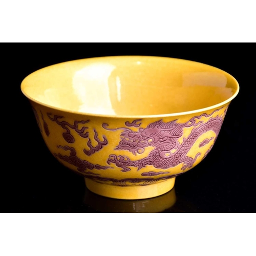 242 - A Chinese aubergine and yellow dragon bowl, the exterior with two incised dragons chasing flaming pe... 