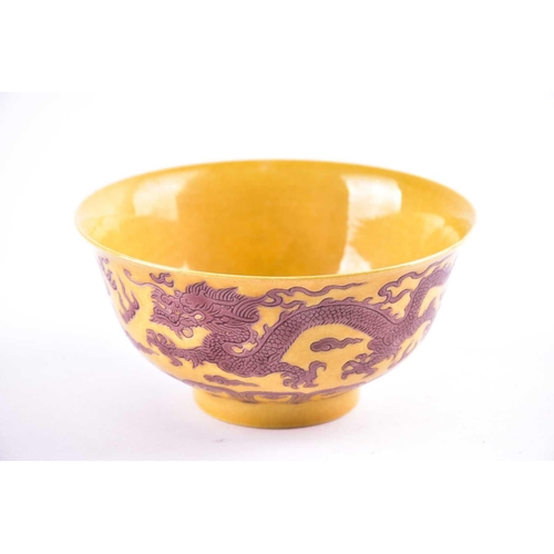 242 - A Chinese aubergine and yellow dragon bowl, the exterior with two incised dragons chasing flaming pe... 