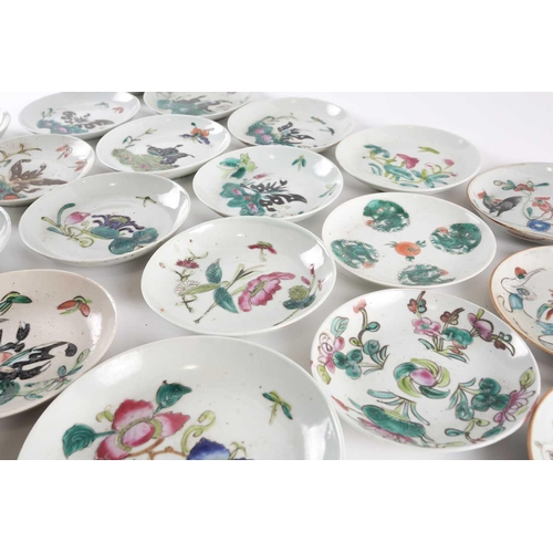 244 - A quantity of Chinese saucers, early 20th century, loosely painted in enamels with butterflies above... 