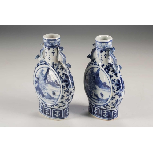 247 - A pair of Chinese blue & white moon flasks, Qing, late 19th century, each with ruyi sceptre handles,... 