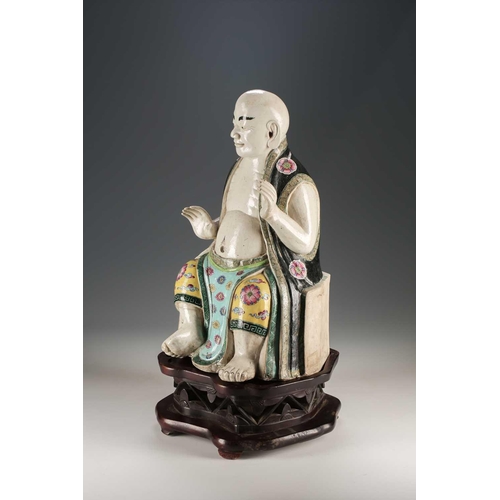 256 - A Chinese porcelain figure of a seated Luohan, Qing, 18th/19th century, his facial features, fingers... 