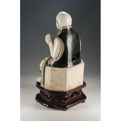 256 - A Chinese porcelain figure of a seated Luohan, Qing, 18th/19th century, his facial features, fingers... 