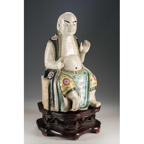 256 - A Chinese porcelain figure of a seated Luohan, Qing, 18th/19th century, his facial features, fingers... 