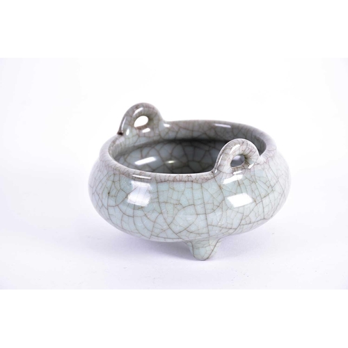 294 - A Chinese celadon Ge glaze censer, Qing, 18th century or later, of squat circular form with two appl... 