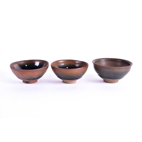 304 - Three Chinese Jian ware 'Hares Fur' tea bowls, Ming and later, each with deep rounded sides, the thi... 