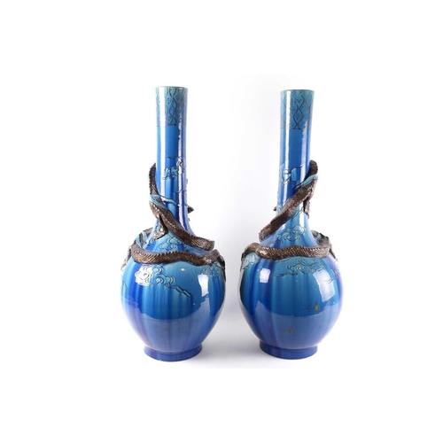 307 - A pair of large Japanese pottery dragon vases, Meiji/Taisho period, the onion shaped bodies with a d... 