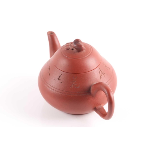 310 - A small Yixing teapot, 20th century, of compressed form, the lid knop modelled as a branch with flow... 