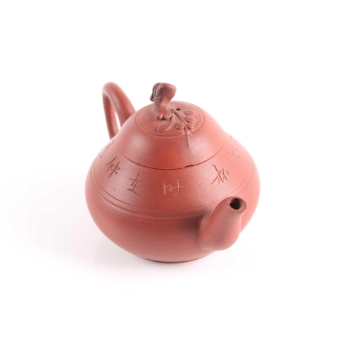 310 - A small Yixing teapot, 20th century, of compressed form, the lid knop modelled as a branch with flow... 