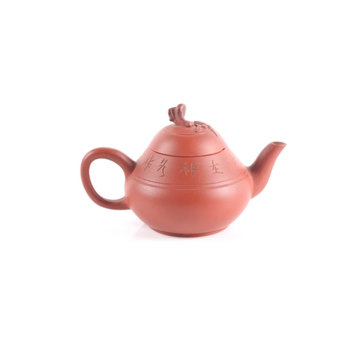 310 - A small Yixing teapot, 20th century, of compressed form, the lid knop modelled as a branch with flow... 