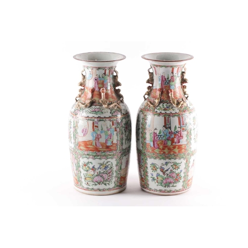 311 - A pair of Canton enamel vases, Qing, 19th century, the flared rim above gilt shi-shi handles and chi... 