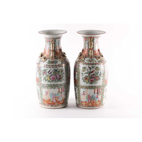 311 - A pair of Canton enamel vases, Qing, 19th century, the flared rim above gilt shi-shi handles and chi... 