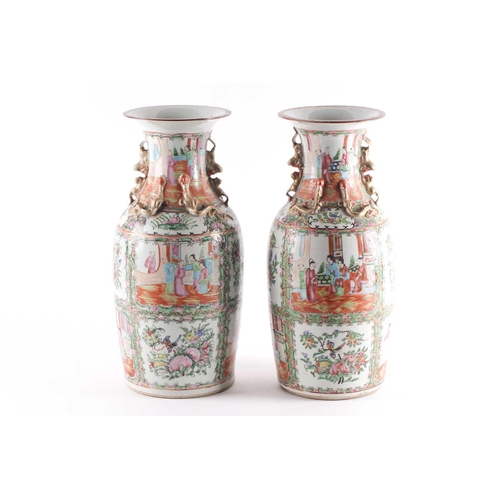 311 - A pair of Canton enamel vases, Qing, 19th century, the flared rim above gilt shi-shi handles and chi... 