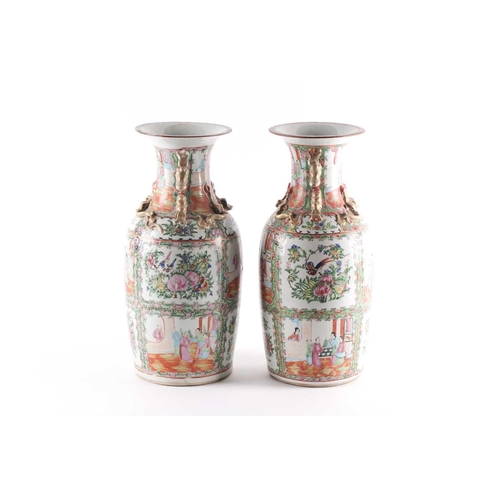 311 - A pair of Canton enamel vases, Qing, 19th century, the flared rim above gilt shi-shi handles and chi... 