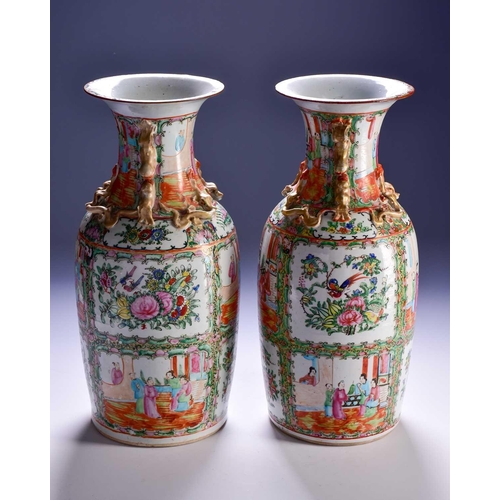 311 - A pair of Canton enamel vases, Qing, 19th century, the flared rim above gilt shi-shi handles and chi... 