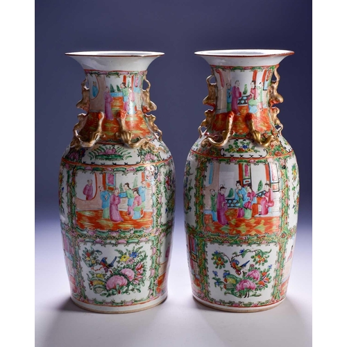 311 - A pair of Canton enamel vases, Qing, 19th century, the flared rim above gilt shi-shi handles and chi... 