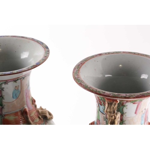 311 - A pair of Canton enamel vases, Qing, 19th century, the flared rim above gilt shi-shi handles and chi... 