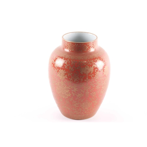 313 - A Chinese coral ground vase, the shoulder with gilt ruyi and meandering key bands, above lotus flowe... 