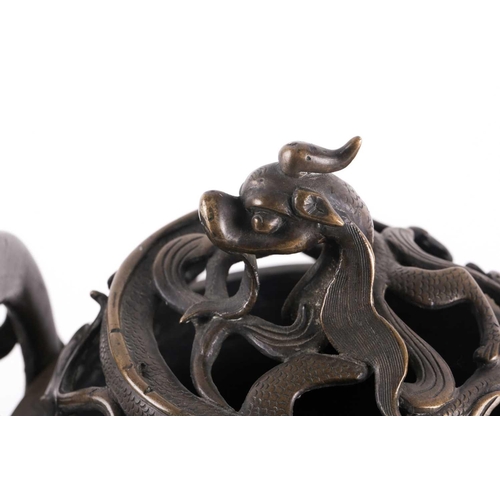 321 - A Chinese bronze censer, late Qing, the openwork cover with a long eared chilong amongst meandering ... 