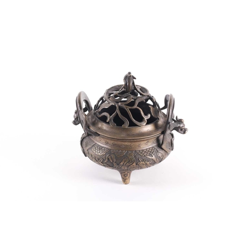 321 - A Chinese bronze censer, late Qing, the openwork cover with a long eared chilong amongst meandering ... 