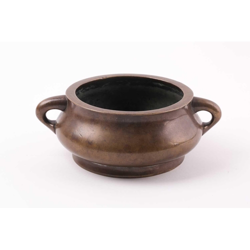 332 - A Chinese bronze censer, Qing, 18trh century, of compressed circular cushion form, with loop handles... 