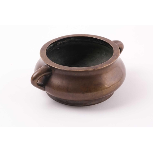 332 - A Chinese bronze censer, Qing, 18trh century, of compressed circular cushion form, with loop handles... 