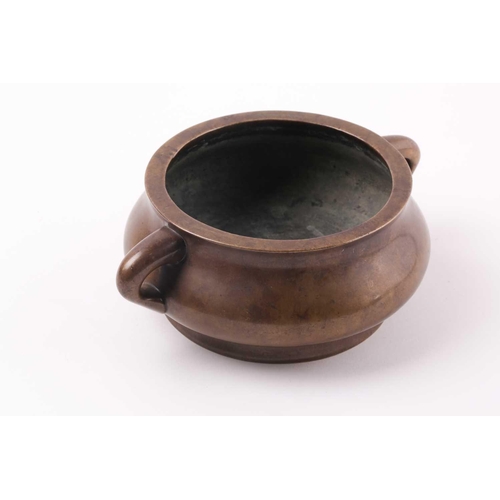 332 - A Chinese bronze censer, Qing, 18trh century, of compressed circular cushion form, with loop handles... 