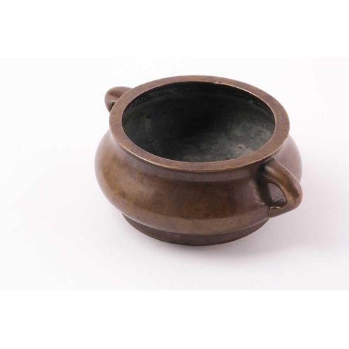 332 - A Chinese bronze censer, Qing, 18trh century, of compressed circular cushion form, with loop handles... 