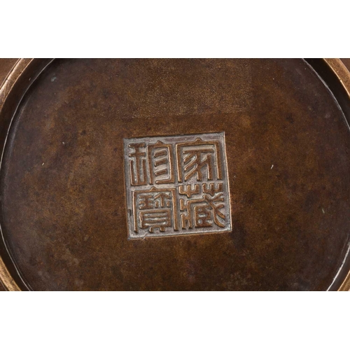 332 - A Chinese bronze censer, Qing, 18trh century, of compressed circular cushion form, with loop handles... 