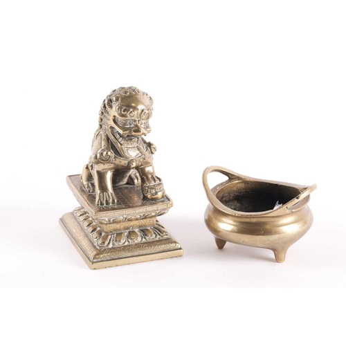 334 - A Chinese bronze censer and Buddhist lion, the censer with sprung handles, on three short feet, cast... 