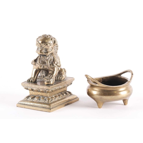 334 - A Chinese bronze censer and Buddhist lion, the censer with sprung handles, on three short feet, cast... 