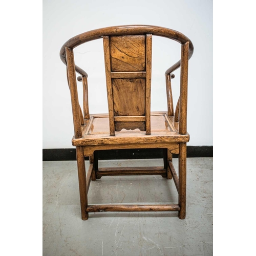 38 - A Chinese horseshoe back armchair, late Qing, the bask panel carved with lotus, with a chamfered rec... 