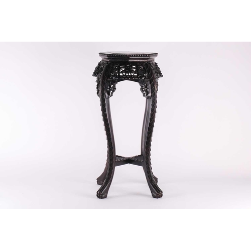 49 - A Chinese carved hardwood vase stand, late Qing, the octagonal top with inset rouge marble panel, ab... 