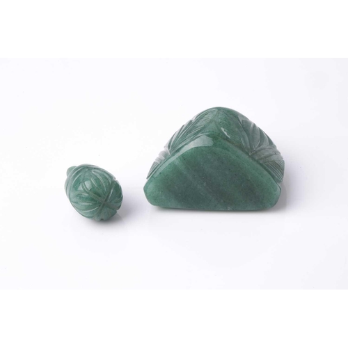 70 - An Eastern carved variegated green hardstone scent bottle of trapezoidal section with pommel carved ... 