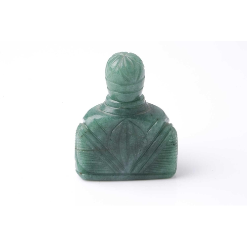 70 - An Eastern carved variegated green hardstone scent bottle of trapezoidal section with pommel carved ... 