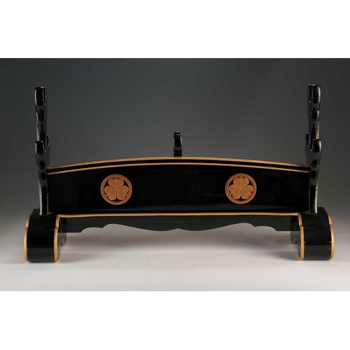 77 - A Japanese black lacquer katanakake, early 20th century, with four gilt lacquer Tokugawa family mons... 