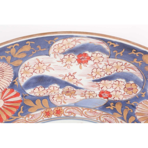 85 - A large Japanese imari dished charger, Edo period, 18th century, the centre with floral display fram... 