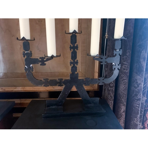 51 - A pair of 20th century five sconce black iron candelabra table lamps, each with faux candles and tas... 