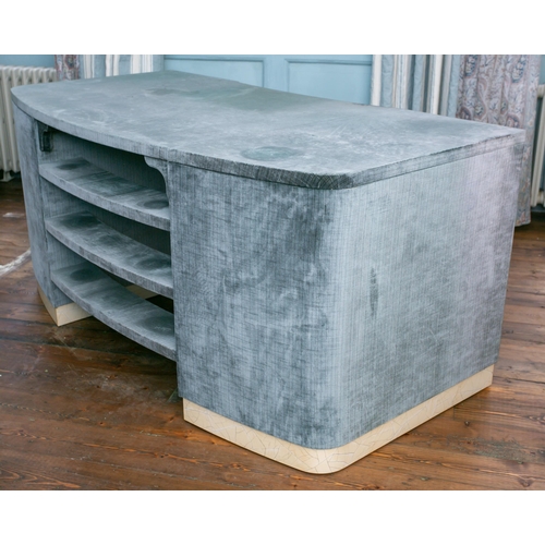 93 - A contemporary eau de nil velvet covered cove kneehole desk fitted with six pedestal drawers and a d... 