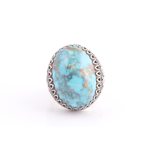 107 - A large Persian silver gentleman's ring, set with a turquoise coloured stone, a short inscription on... 