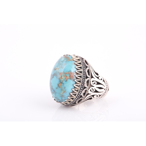 107 - A large Persian silver gentleman's ring, set with a turquoise coloured stone, a short inscription on... 