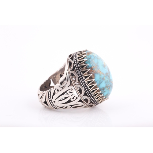 107 - A large Persian silver gentleman's ring, set with a turquoise coloured stone, a short inscription on... 