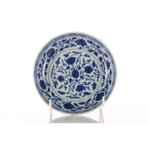 108 - A Chinese blue & white saucer dish, painted with lotus flowers and tendrils within a scrolling borde... 