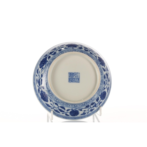 108 - A Chinese blue & white saucer dish, painted with lotus flowers and tendrils within a scrolling borde... 