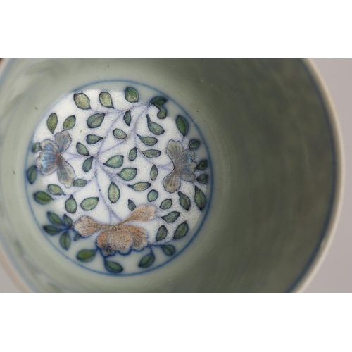 110 - A Chinese porcelain doucai tea bowl, of tapering form, painted with blossoming flowers within colour... 