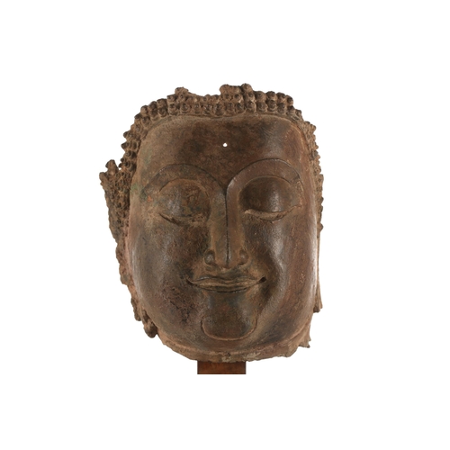 111 - A bronze head of Buddha, 18th century, South East Asia, the hair in tight curls above the serene fac... 