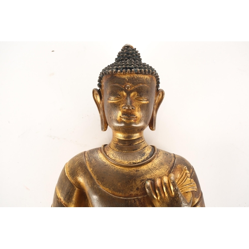 113 - A gilt bronze Buddha Shakyamuni, Nepal or Tibet, modelled standing in a long flowing robe, the hair ... 