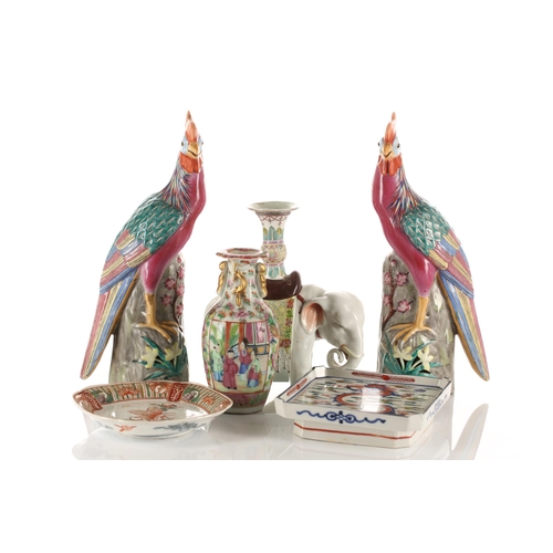 133 - A Pair of Chinese porcelain pheasants, late 20th century, each standing on a pierced rockwork mand f... 